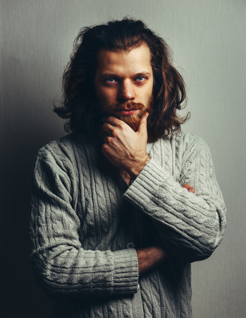 Portrait Of handsome man with beard and long hairの写真素材