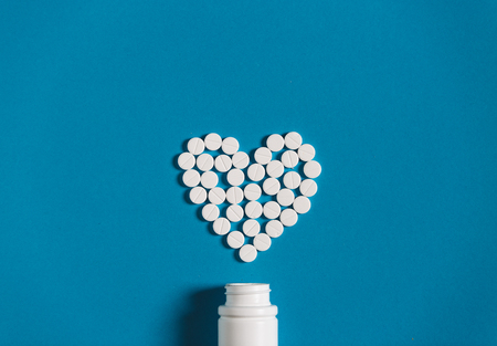 Sign Heart From White Tablets Medicament On Blue Background, Topv View. Creativity Medicine Conceptの写真素材