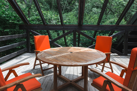 Summer country terrace with a table and orange chairs. Interior detailsの写真素材