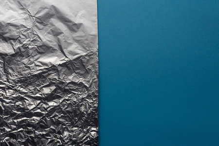 Texture Silver Aluminum Foil On Blue Background, Flat Layの写真素材