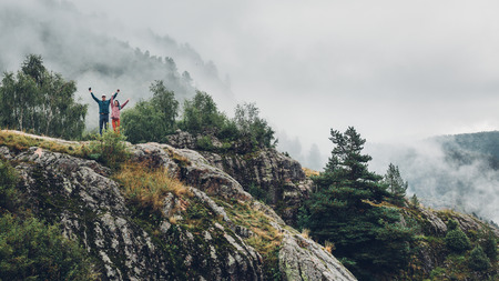 Hiking Couple In Love Enjoying View Of Mountains And Clouds With Copy-Spaceの写真素材