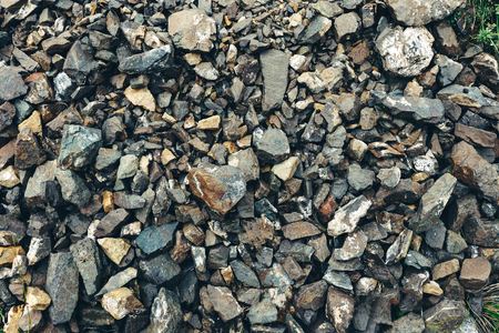 Closeup gravel surface wet old marble stone. Rock texture backgroundの写真素材