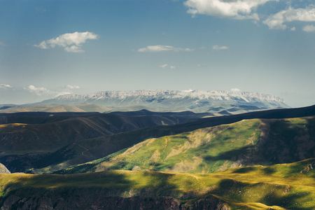 Picturesque Summer Mountain Range, Green Hills Overview Blue Sky. Elbrus region, Russiaの写真素材