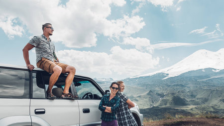 Young Travelers Friends Enjoys View Of Mountains In Summer. Elbrus Region, Norten Caucasus, Russiaの写真素材