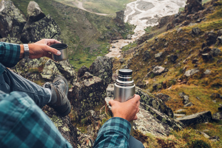 Hiking Adventure Tourism Vacation Holiday Concept. Unrecognizable Traveler Man Holding In His Hand And Enjoy View Of Summer Valley, Rear Viewの写真素材