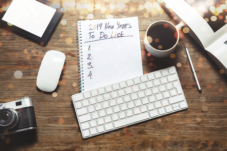 New year Motivation in 2019 Concept. Notepad with keyboard, cupboard, cupboard, top view, flat lay. Workplace of freelance designer, blogger, photographer in lightsの写真素材