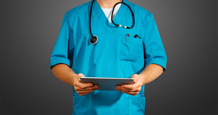 Concept of global medicine and healthcare. Unrecognizable doctor using digital tablet. Diagnostics and modern technology on black backgroundの写真素材