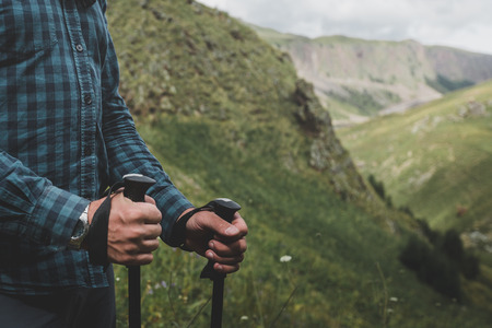 Unrecognizable Traveler With Trekking Poles In Hands. Journey Outdoor