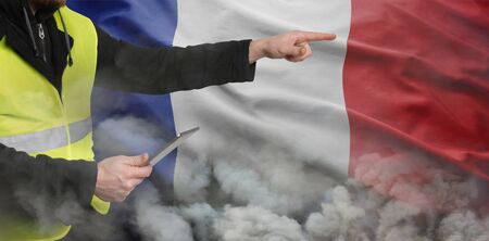 Yellow vests protests. An unrecognizable person organizes and directs protesters through modern technology and social networks. The concept of revolution and protest, the struggle for equal rights, the electoral movementの写真素材