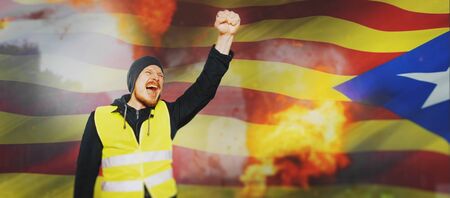 Protests yellow vests in Catalonia. Man raised his hand into a fist and shouted separatism concept 