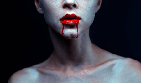 Zombie vampire woman with bloody lips and blue skin portrait. Fashion glamour halloween art design conceptの写真素材