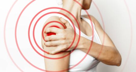 Acute shoulder pain. Hand touch the painful point. Pain area highlighted in red. Healthcare and medical conceptの写真素材