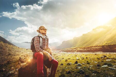 Traveler Man Sitting On A Background Of A Picturesque Mountain Landscape. Motivation, Travel,...