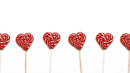 Heart Shaped Lollipops In Row On White Background. Global Concept And Symbol Of Love. Love and Holiday Greeting Card Background
の写真素材