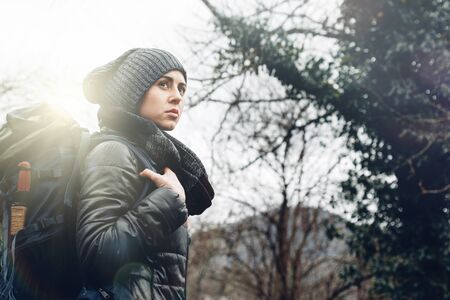 Young woman with backpack in forest. Concept Travel Tourism Adventure Hike and People