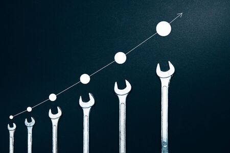 Creative Concept Of Professional Growth. Different Sizes Of Wrenches On A Dark Background, Top View Flat Lay with Infographの写真素材