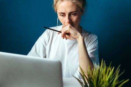 Concentrated Woman Looking At Laptop Screen. Education, Online shopping, Remote Work And Other Meanings Conceptの写真素材