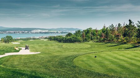 Green Golf Course With Scenic Sea Viewの写真素材