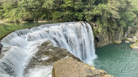 Beautiful waterfall in the jungle, long exposure, panoramic view