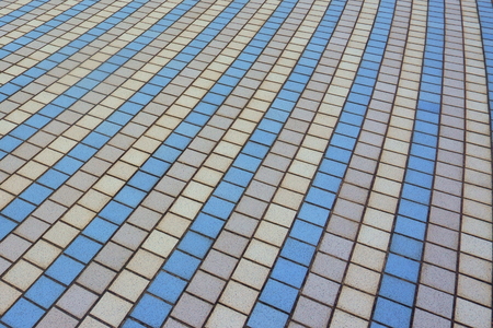 multi-colored tiles from which a pedestrian road in the park is made, details and a close-up of the infrastructure in the cityの写真素材