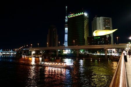 TOKYO, Japan - Sept 09 2018: Cityscape with the Sumida River, Tokyo sky tree, Asahi Beer Hall at nightのeditorial素材