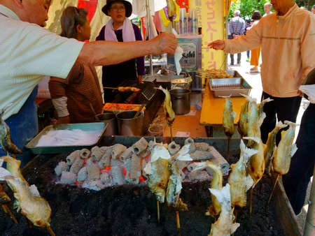 Tokyo / Japan May 05, 2019: Grilled fish on stick. Tasty and healthy. Japanese street foodのeditorial素材