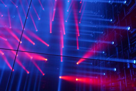 Scene illuminated by spotlights blue and red rays of light. Reflection floor mirrorの写真素材
