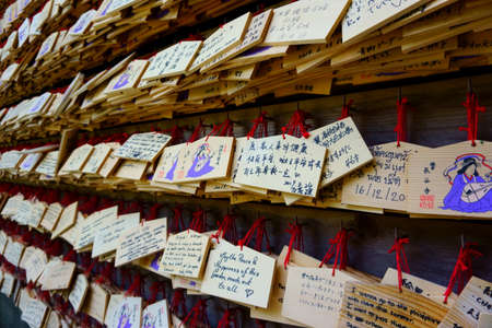Kamakura / Japan - Sept 09, 2019: Hase-dera temple. Writing a wish on a small wooden plaque Ema and hanging it among the wishes of other visitorsのeditorial素材