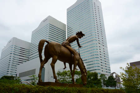 Yokohama Japan - Sept 13, 2019: Venanzo Crocettis sculpture âThe Young Knight of Peaceâ. Queens towers in the backgroundのeditorial素材