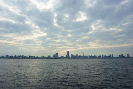 Rain clouds over city and seaの写真素材
