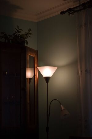 White light lamp in the corner of a dark roomの写真素材