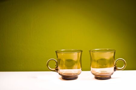 glass vessels standing on the white table, isolated backgroundの写真素材