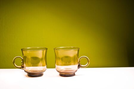 glass vessels standing on the white table, isolated backgroundの写真素材