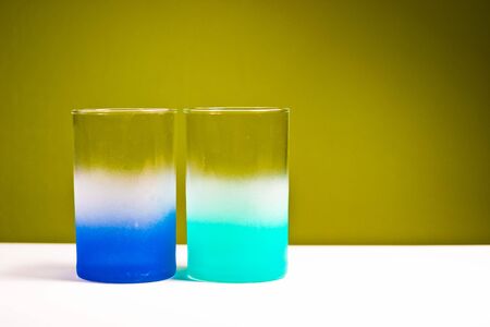 glass vessels standing on the white table, isolated backgroundの写真素材