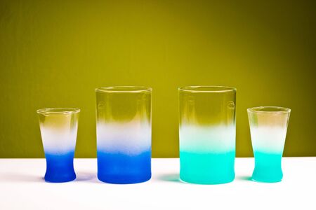 glass vessels standing on the white table, isolated backgroundの写真素材