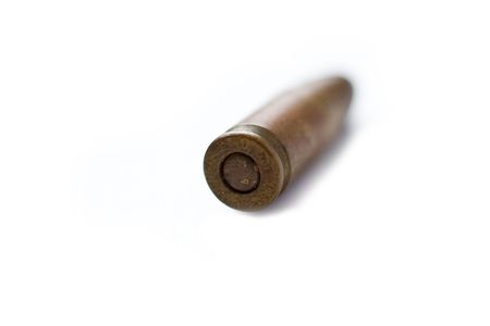 bullet on white, 9mm silver tipped bullet closeup on white, highkey and processed high-contrastの写真素材