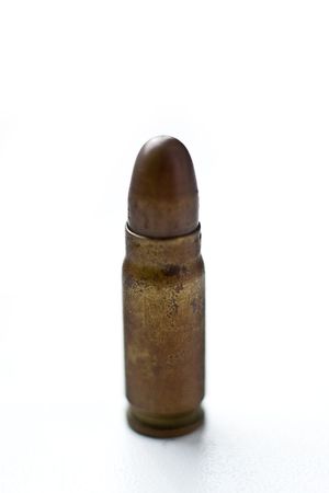 bullet on white, 9mm silver tipped bullet closeup on white, highkey and processed high-contrastの写真素材