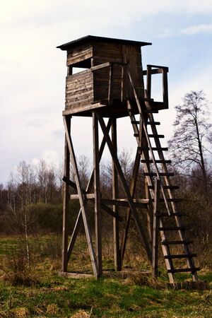 wooden structure standing near the forest on a sunny afternoonの写真素材
