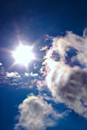 occurring yellow sun behind the clouds on a warm evening の写真素材