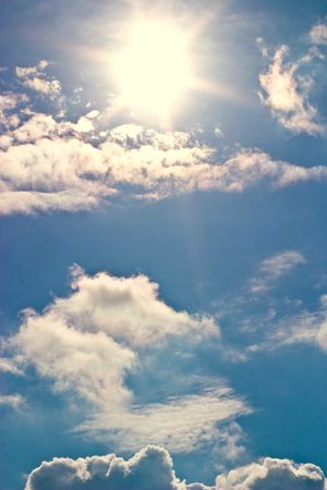 occurring yellow sun behind the clouds on a warm evening の写真素材