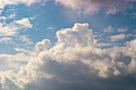 occurring yellow sun behind the clouds on a warm evening の写真素材