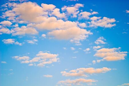occurring yellow sun behind the clouds on a warm evening の写真素材