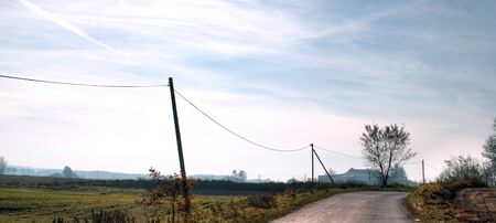 occurring yellow sun behind the clouds on a warm eveningの写真素材