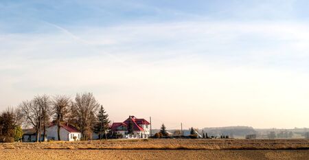 occurring yellow sun behind the clouds on a warm eveningの写真素材