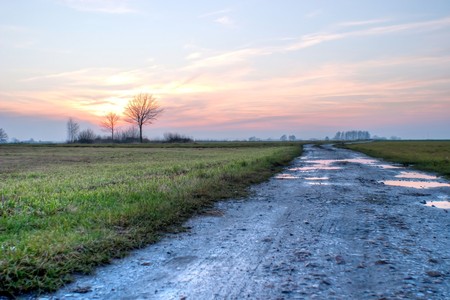 road, ground road under fluffy clouds, fall scenic roadの写真素材