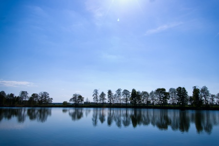 occurring yellow sun behind the clouds on a warm eveningの写真素材