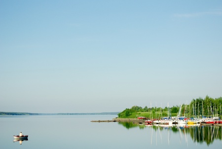 A rural blue lake and a green forestの写真素材