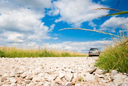 country road, stone road under fluffy clouds, fall scenic road