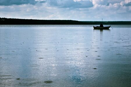 boat on the blue lake with cloudy sky, boats seriesの写真素材