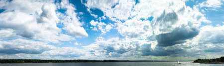 occurring yellow sun behind the clouds on a warm eveningの写真素材